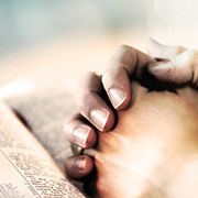 hands on bible praying